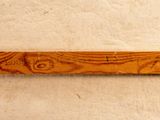 a close up of a piece of wood with a toothbrush on it