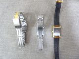 three watches sitting next to each other on a table