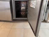a silver refrigerator with a door open in a kitchen