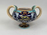 an image of a blue and gold vase on a white surface