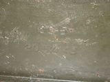 a green box with writing on it sitting on the floor