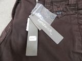 a label on a pair of brown pants with a tag attached to it