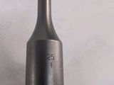 a close up of a metal object on a white surface