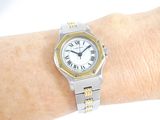 a woman ' s wrist that has a watch on it