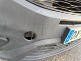 a close up of a car ' s front bumper with a hole in it