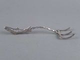 a close up of a fork with a bird on it