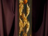 dried fish in a glass box on a purple cloth