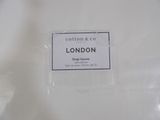 a sign that says cotton & co london on the back of a toilet