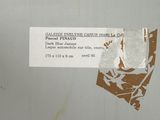 a piece of paper taped to a wall with a sticker on it