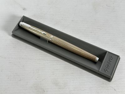 an image of a pen sitting on top of a black box