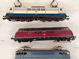 three different trains on display in a display case