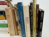 a lot of books that are stacked on top of each other
