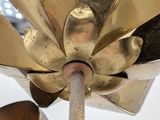 a close up of a metal object with a flower on top of it