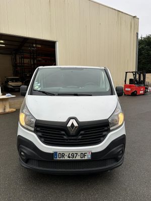 the front of a white van parked in front of a building