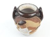 a brown and white vase with a picture of a baseball player on it