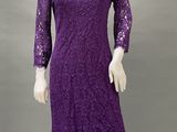 a mannequin wearing a purple lace dress with long sleeves