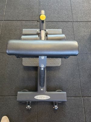 a person standing next to a machine in a gym