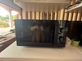 a microwave sitting on top of a white counter