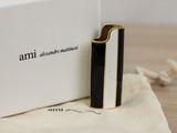 a black and white lighter sitting in front of a white box