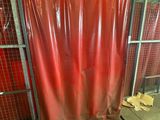a red curtain that is covering a gate in a building
