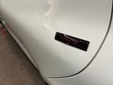 a sticker on the side of a white car