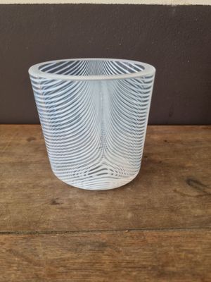 a glass cup that is sitting on a wooden table