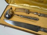 a box with a knife, spoon, and spoon rest inside of it