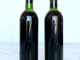 two bottles of wine that are sitting on a table