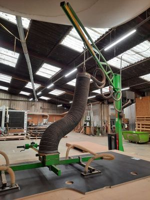 a machine that is working on a piece of wood in a building