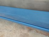a blue bench sitting on the floor in a room