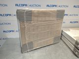a mattress and a box on the floor in front of a wall