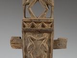 a close up of a wooden sculpture with two birds on it