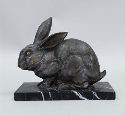 statue of a rabbit on a marble base on a white background