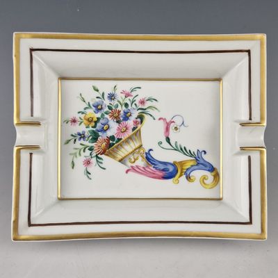 a close up of a plate with flowers and a bird on it