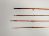 four different types of fishing rods lined up on a wall