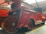 a red fire truck that is parked in a garage