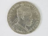a close up of a coin on a white surface with a white background