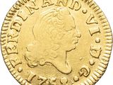 a close up of a gold coin with a woman ' s head on it