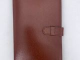 a brown leather notebook with a gold clasp on the front