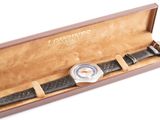 a watch that is in a box on a white surface