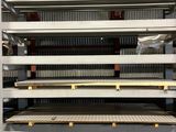 a close up of a metal rack with shelves in a warehouse