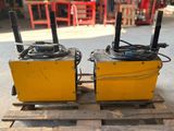 two yellow boxes sitting on top of a pallet with wires attached to them