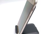 a cell phone that is sitting on top of a stand
