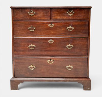 a mahogany chest of drawers with brass handles