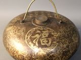 a small metal pot with a handle on a table
