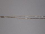 a close up of a silver spoon on a white surface