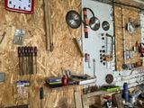 many tools hanging on the wall in this garage