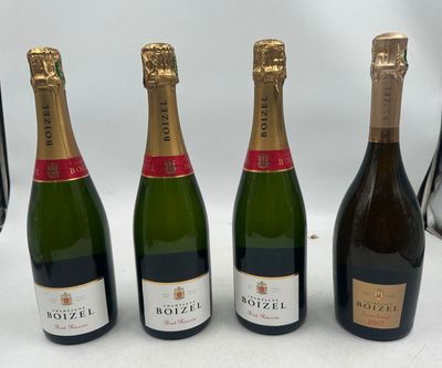 three bottles of champagne are lined up on a table