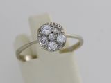 a close up of a diamond ring on a white surface