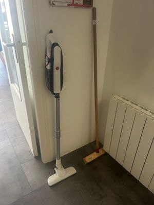 a mop that is next to a radiator in a room